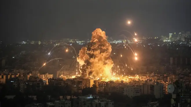 Flames and smoke rise from an Israeli airstrike in Dahiyeh (Bilal Hussein/AP)